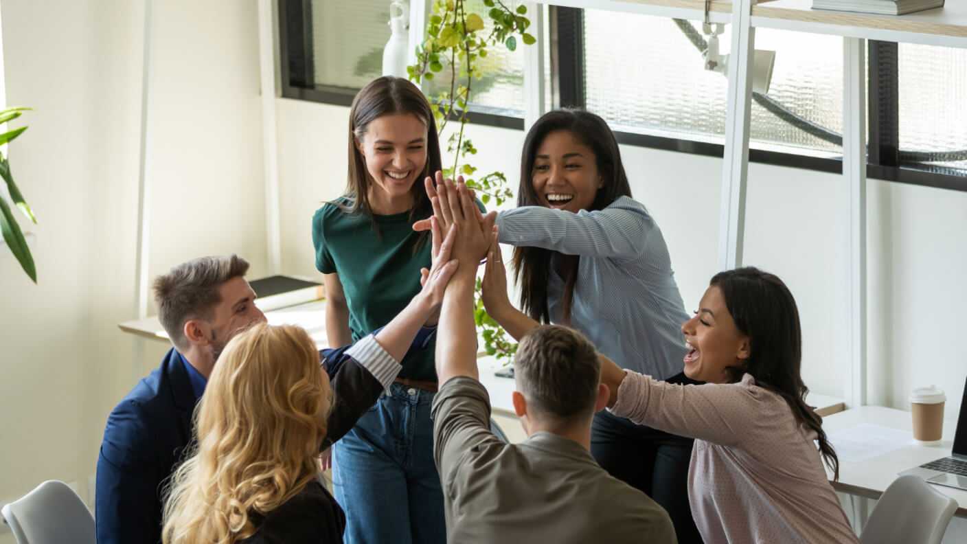 a group of people giving a group high five